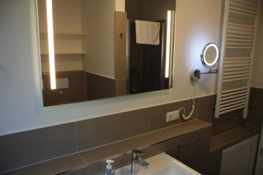 Badezimmer mit viel Komfort. Badezimmer mit Handtuchwärmer und Kosmetikspiegel